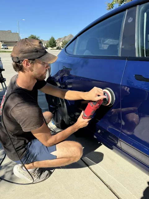 Detailer polishing a vehicle door