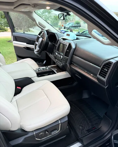 Vehicle cabin showing seats, dashboard and interior surfaces