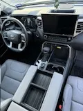 Vehicle cabin showing seats, dashboard and interior surfaces