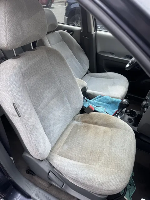 Light-colored front seat with visible staining