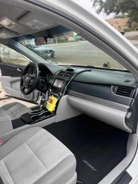 Vehicle cabin showing seats, dashboard and interior surfaces