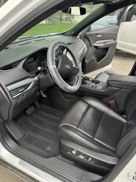 Vehicle cabin showing seats, dashboard and interior surfaces