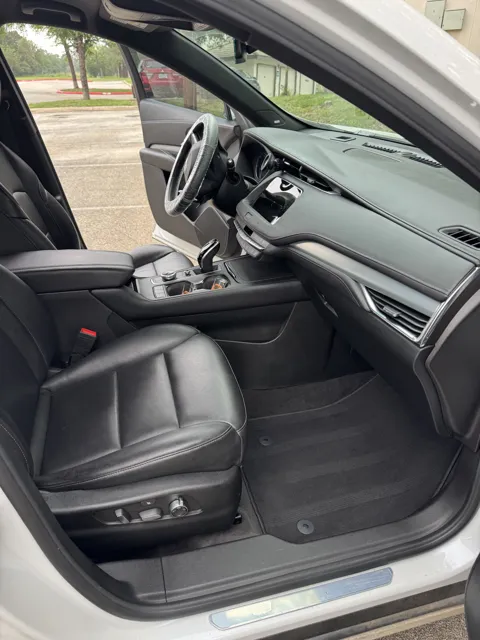 Vehicle cabin showing seats, dashboard and interior surfaces