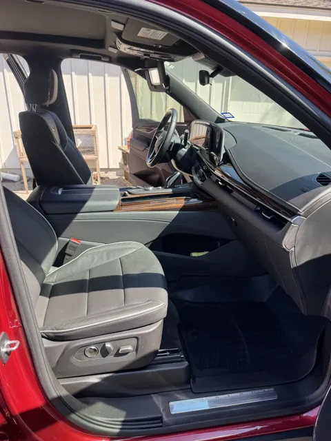 Vehicle cabin showing seats, dashboard and interior surfaces
