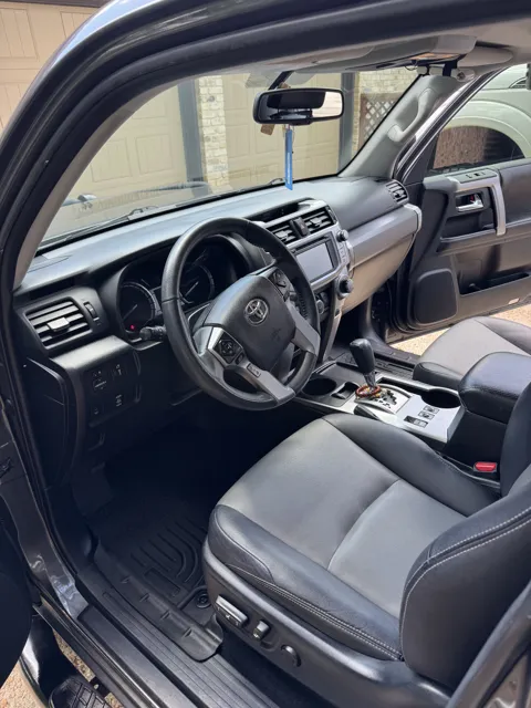 Vehicle cabin showing seats, dashboard and interior surfaces