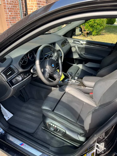 Vehicle cabin showing seats, dashboard and interior surfaces