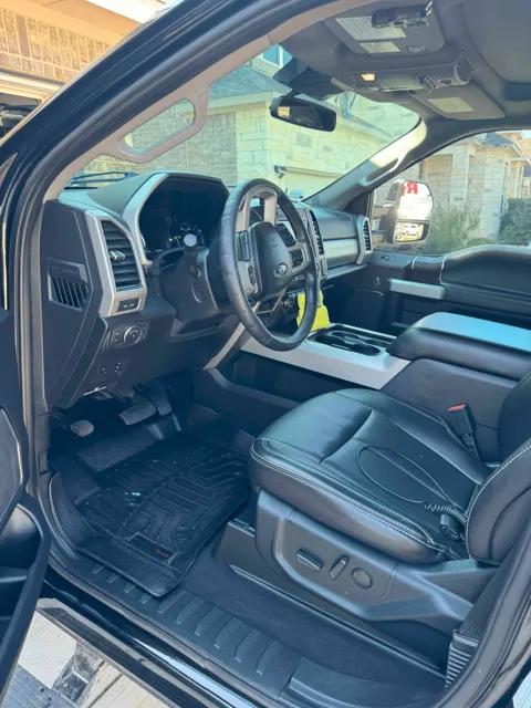 Vehicle cabin showing seats, dashboard and interior surfaces