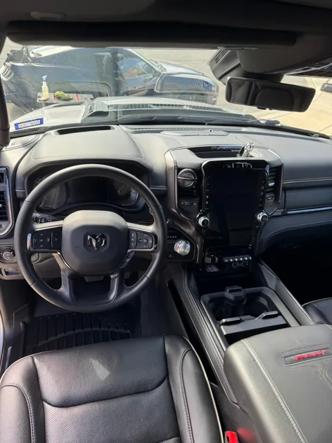 Vehicle cabin showing seats, dashboard and interior surfaces