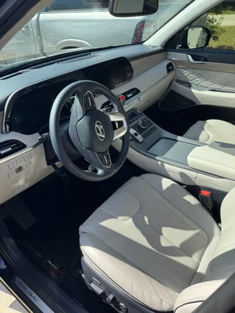 Vehicle cabin showing seats, dashboard and interior surfaces