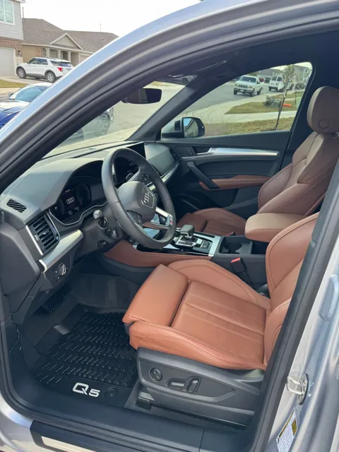 Vehicle cabin showing seats, dashboard and interior surfaces
