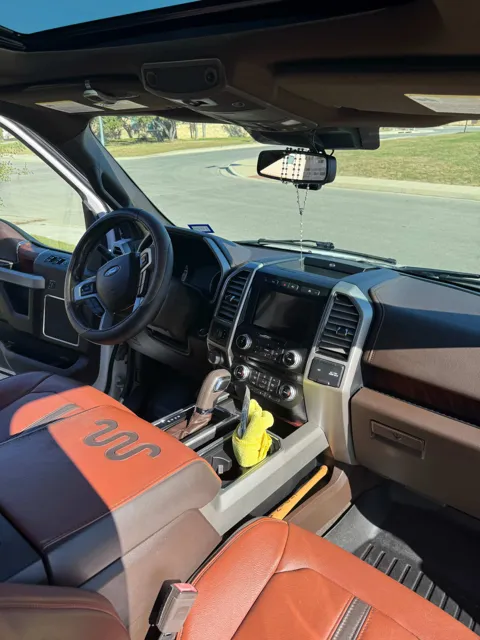 Vehicle cabin showing seats, dashboard and interior surfaces