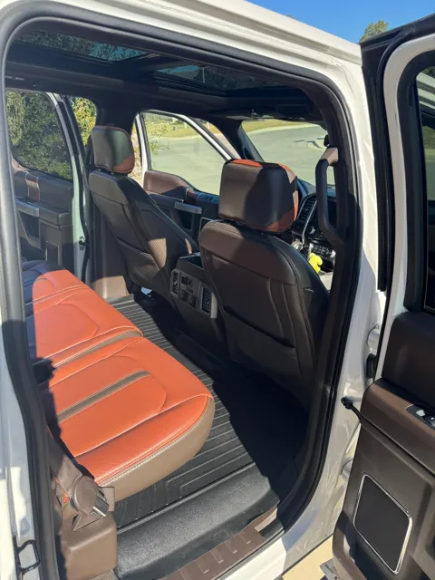 Vehicle cabin showing seats, dashboard and interior surfaces