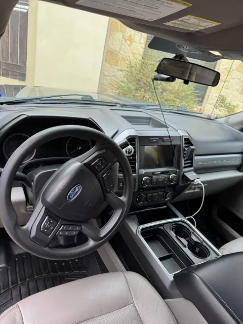 Vehicle cabin showing seats, dashboard and interior surfaces