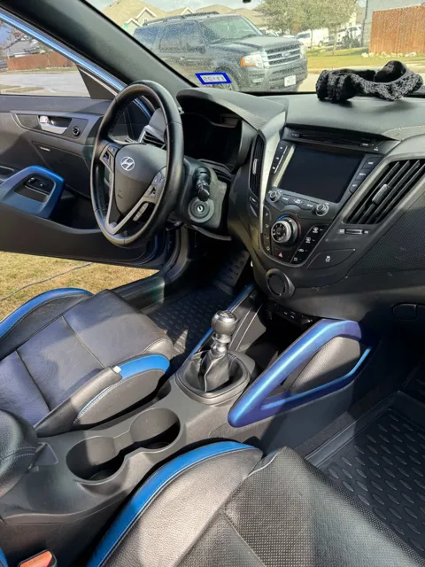 Vehicle cabin showing seats, dashboard and interior surfaces