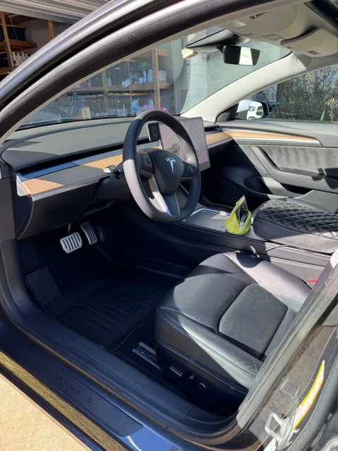 Vehicle cabin showing seats, dashboard and interior surfaces