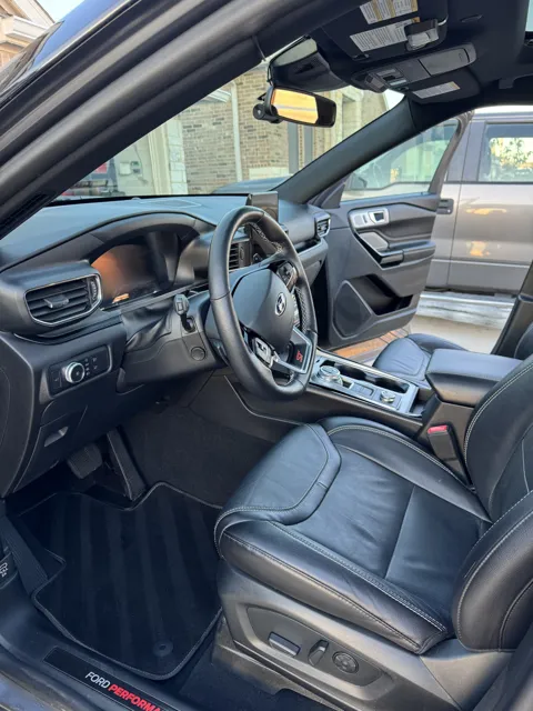 Vehicle cabin showing seats, dashboard and interior surfaces