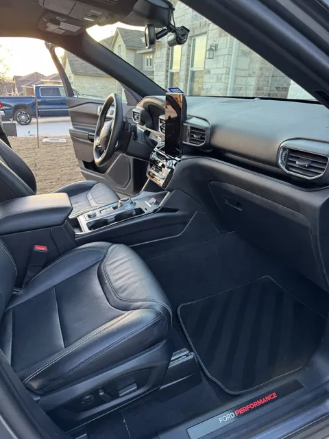 Vehicle cabin showing seats, dashboard and interior surfaces