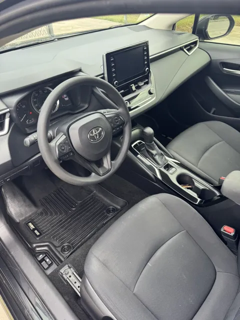 Vehicle cabin showing seats, dashboard and interior surfaces