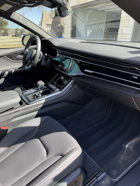 Vehicle cabin showing seats, dashboard and interior surfaces
