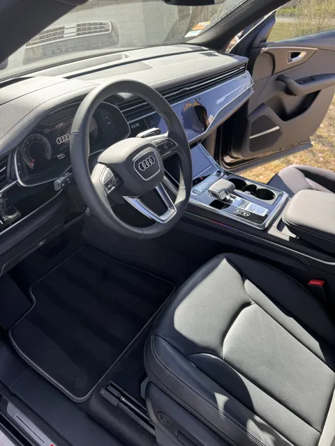 Vehicle cabin showing seats, dashboard and interior surfaces