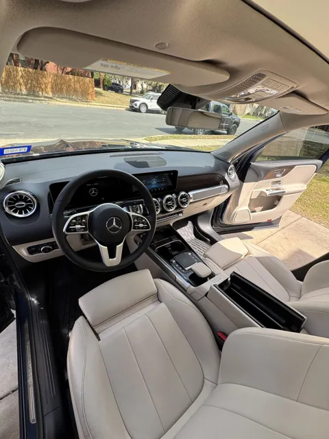Vehicle cabin showing seats, dashboard and interior surfaces