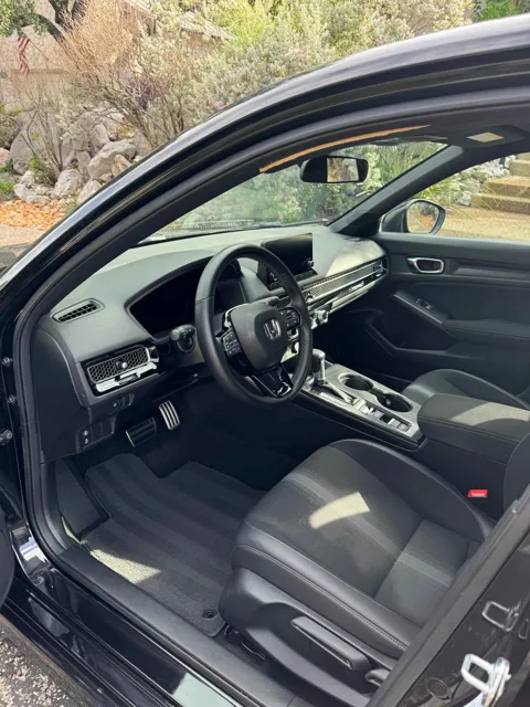 Vehicle cabin showing seats, dashboard and interior surfaces