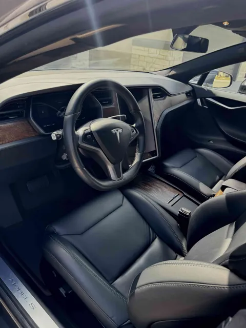 Vehicle cabin showing seats, dashboard and interior surfaces
