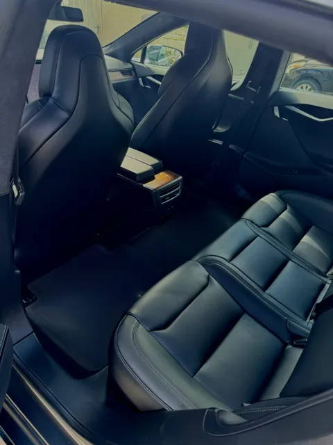 Vehicle cabin showing seats, dashboard and interior surfaces