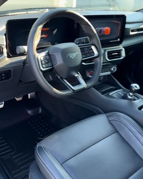 Vehicle cabin showing seats, dashboard and interior surfaces