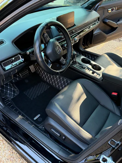 Vehicle cabin showing seats, dashboard and interior surfaces