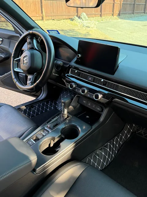Vehicle cabin showing seats, dashboard and interior surfaces
