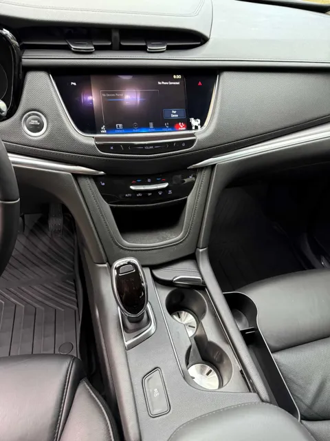 Vehicle cabin showing seats, dashboard and interior surfaces