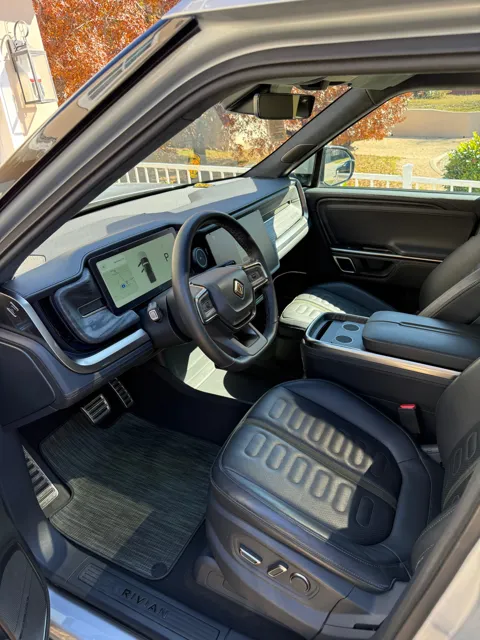 Vehicle cabin showing seats, dashboard and interior surfaces
