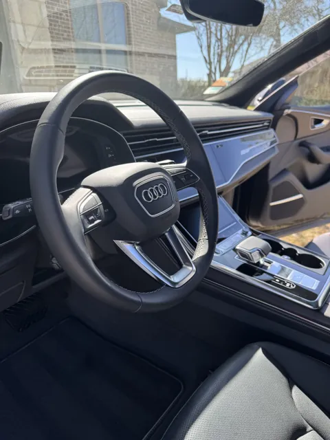 Vehicle cabin showing seats, dashboard and interior surfaces