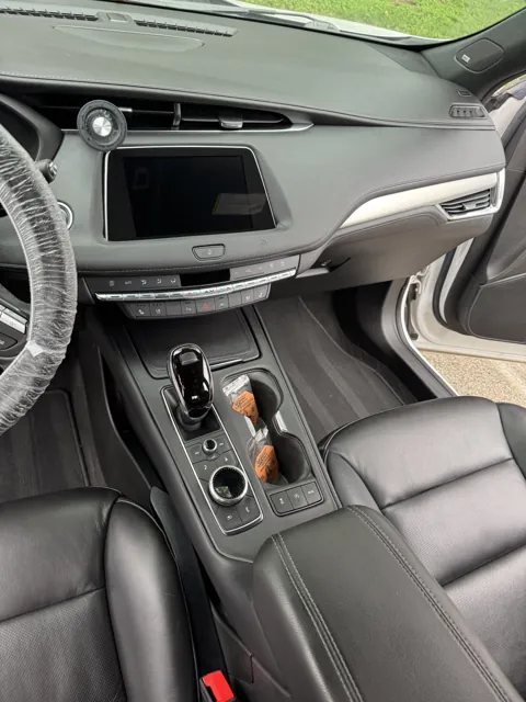 Vehicle cabin showing seats, dashboard and interior surfaces
